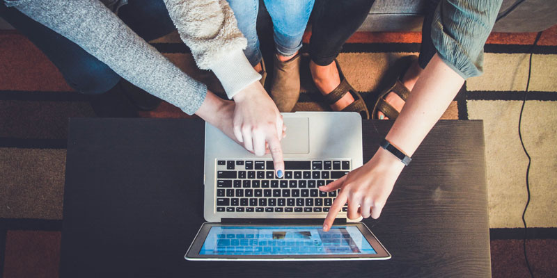 3 women using a laptop