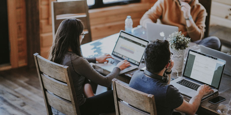 small team working together on computers at desk