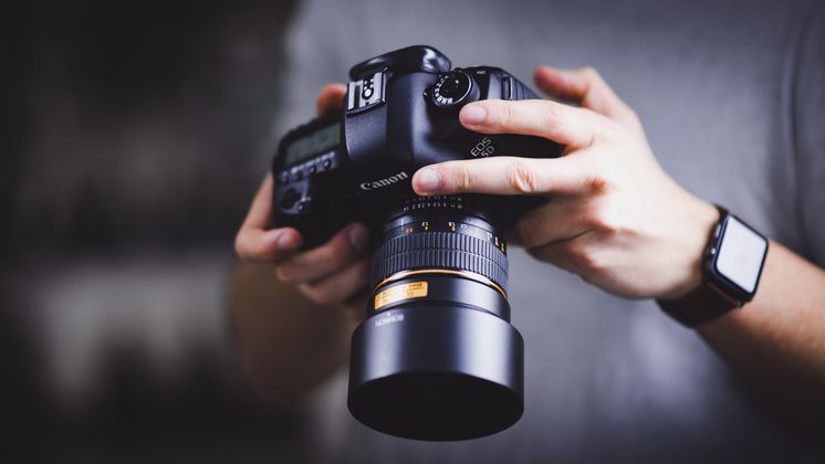 photographer holding camera for commercial photos